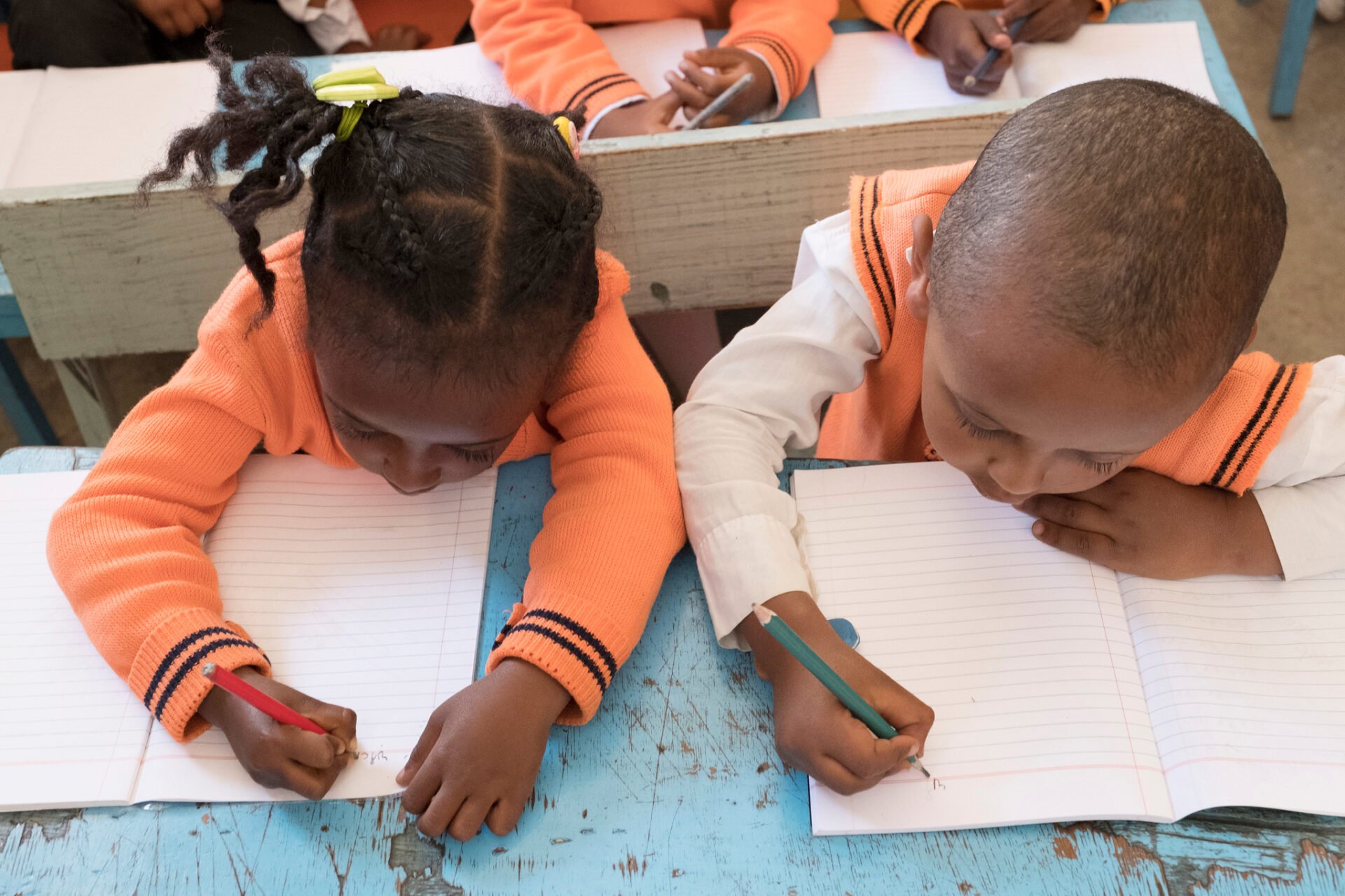 students at a desk writing