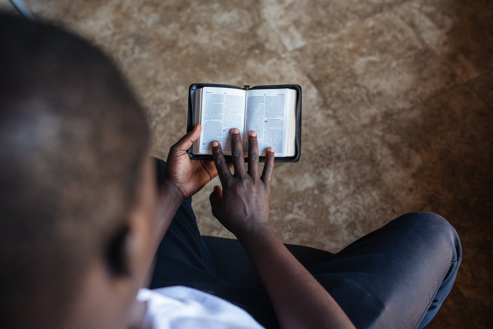 student in africa reading the Bible