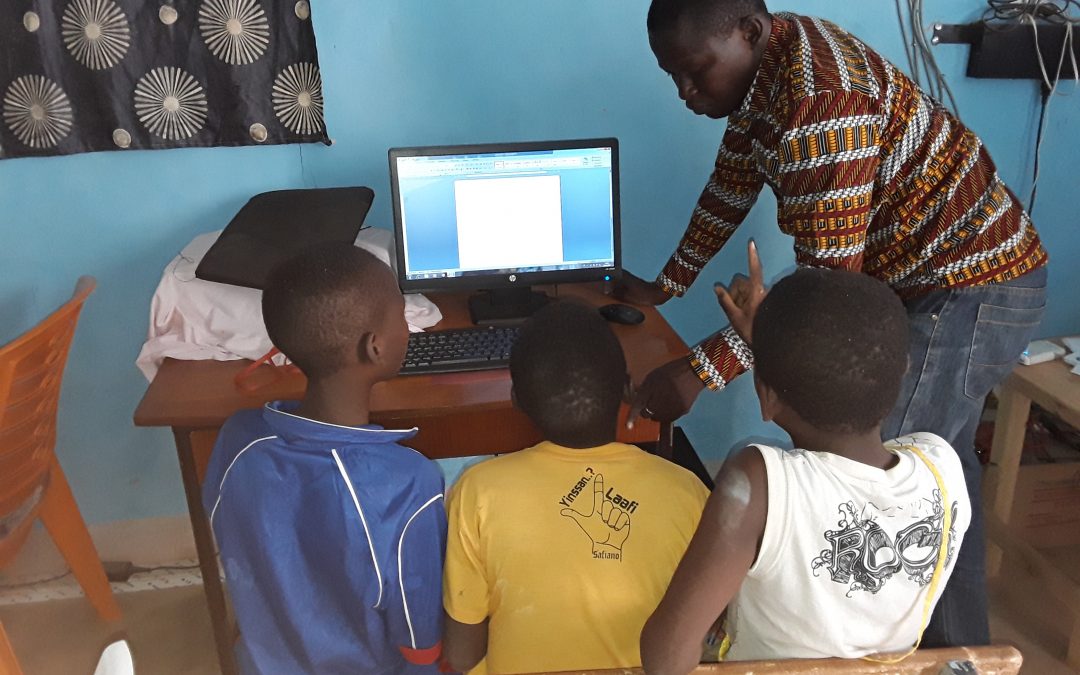 Students with teacher in computer lab in Burkina Faso school