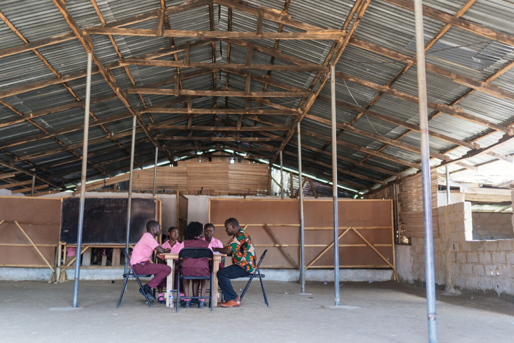 students and teachers in Liberia in a big room