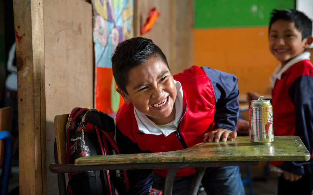 Boy student in Guatemala smiling in classroom