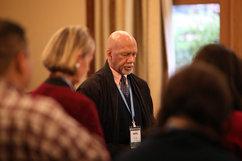 luis sena with edify staff people praying