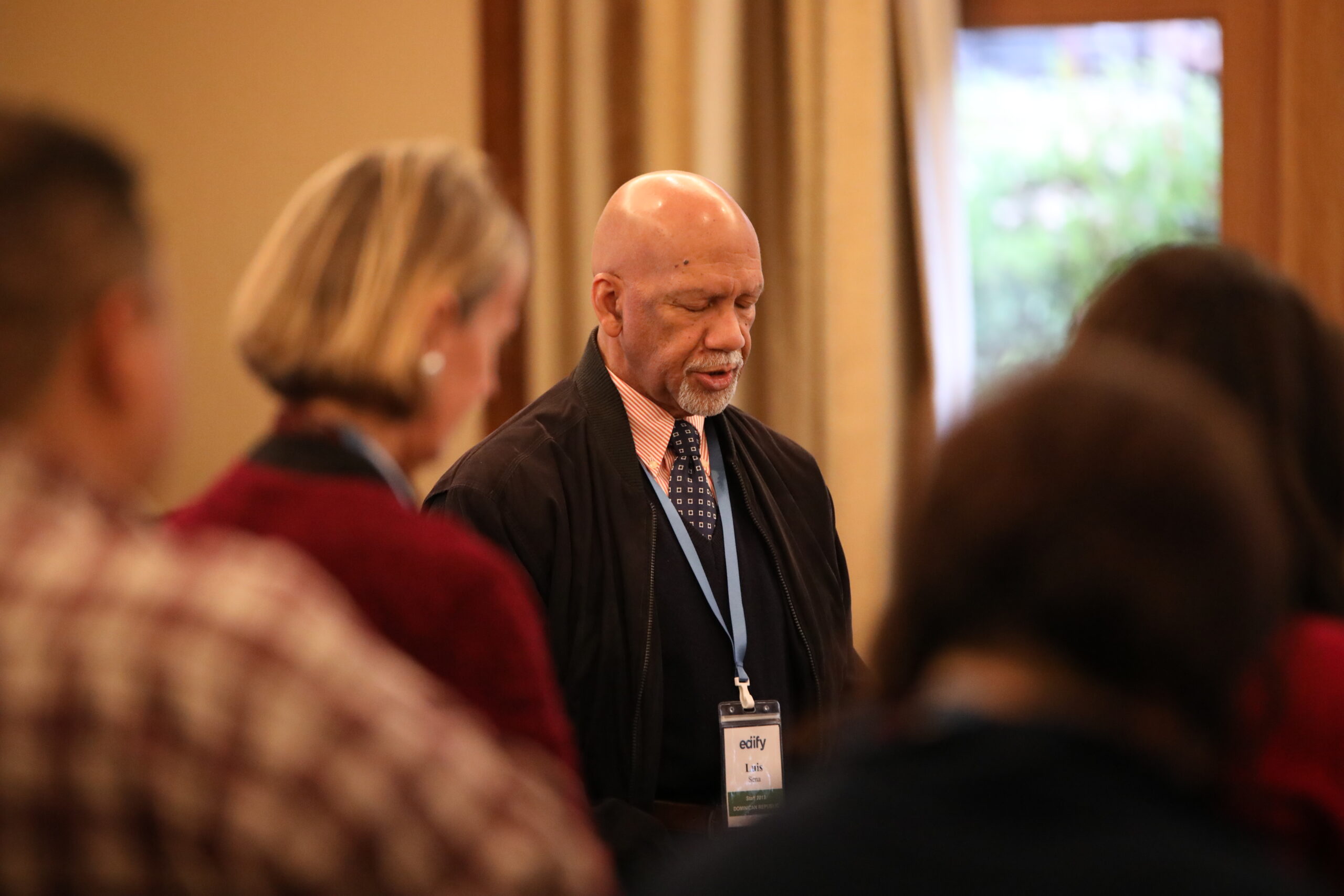 luis sena with edify staff people praying