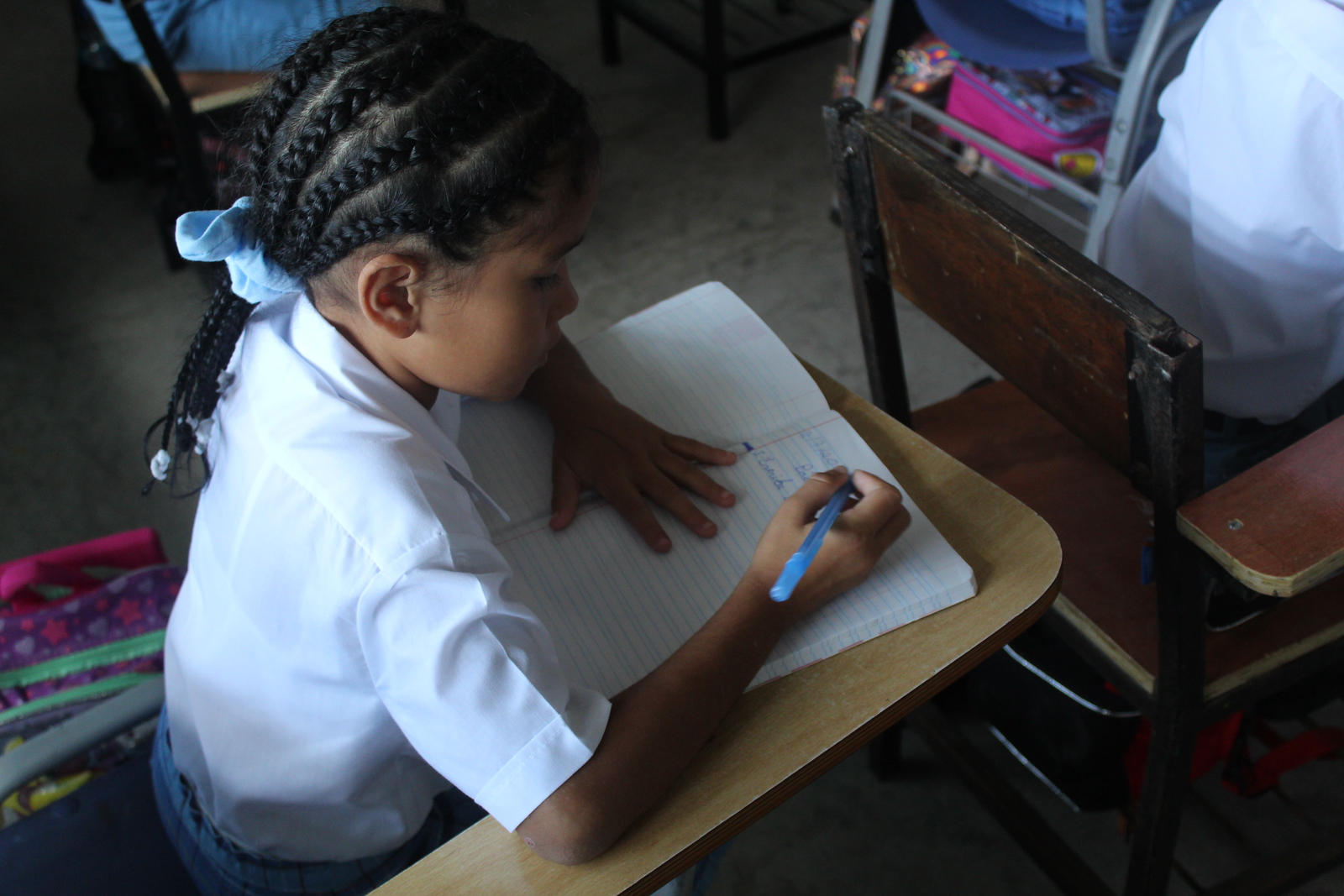 students at a desk writing