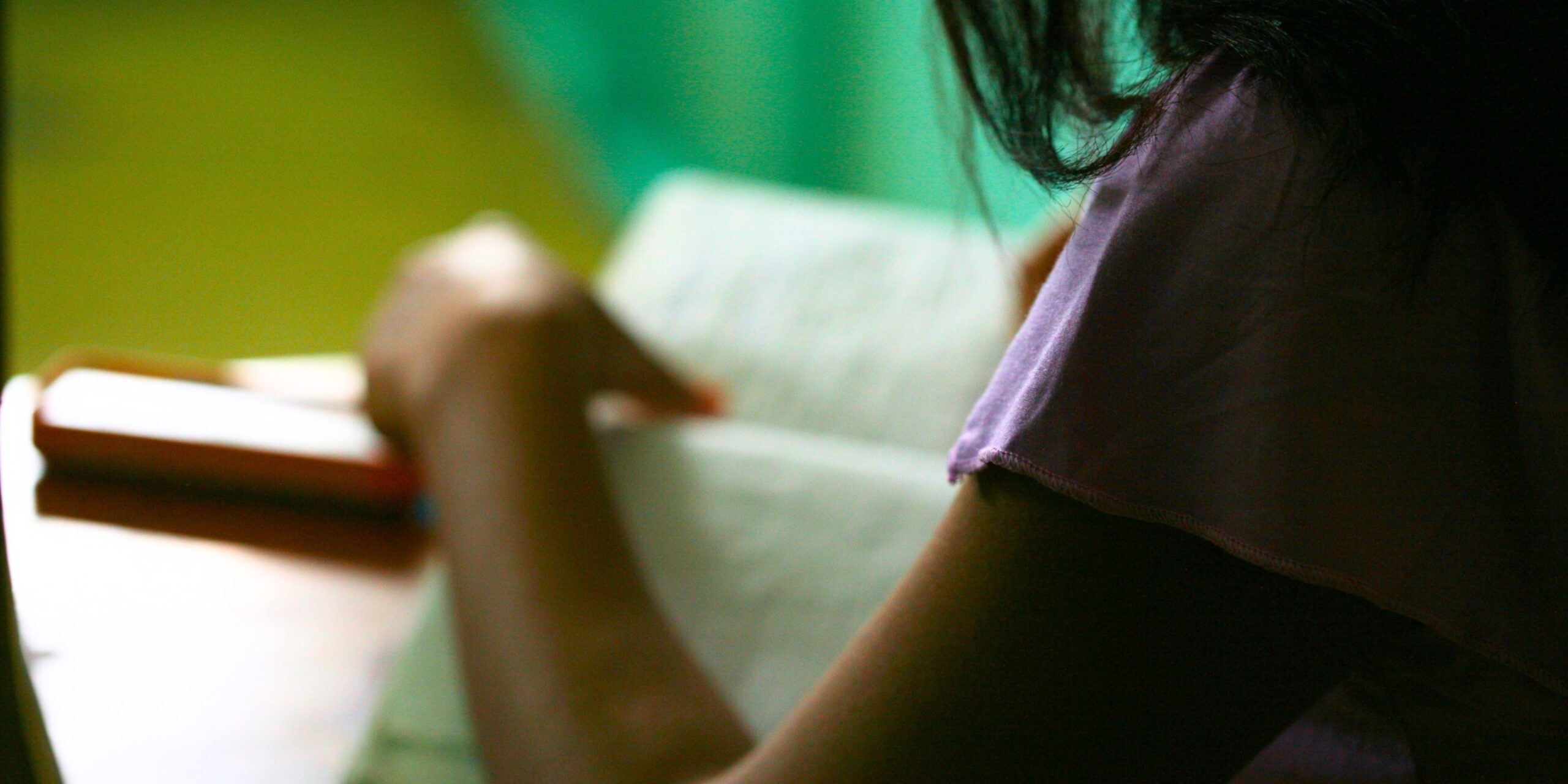 girl writing in a journal in school