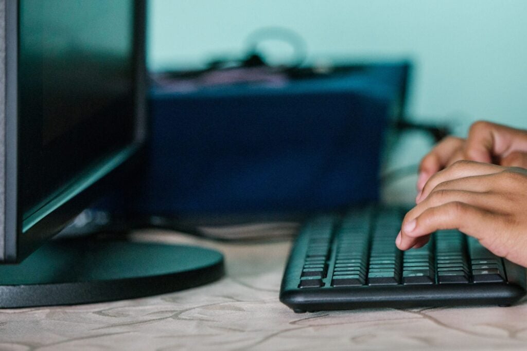 hands typing on a laptop student