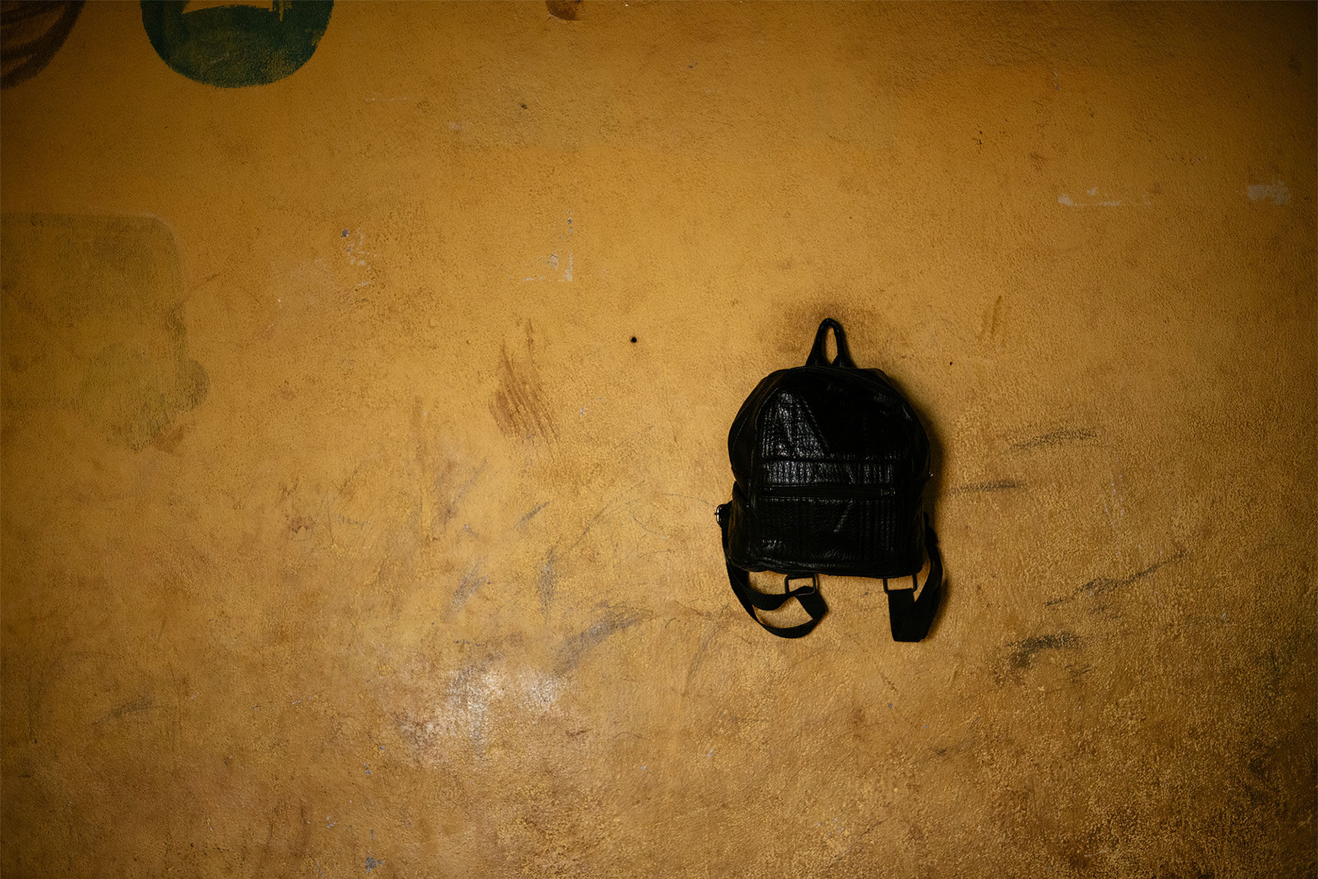 black backpack on school wall