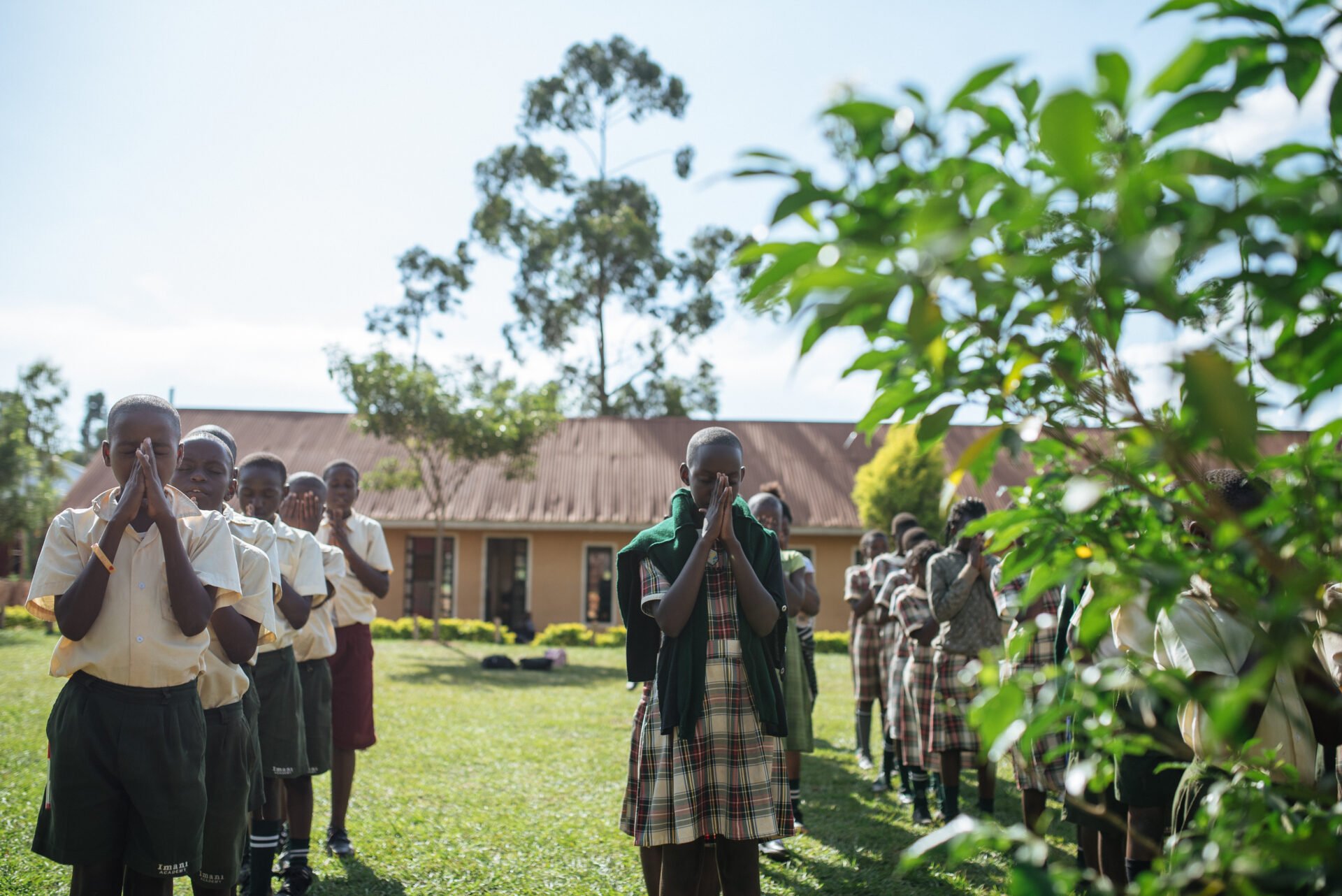 students in Uganda praying
