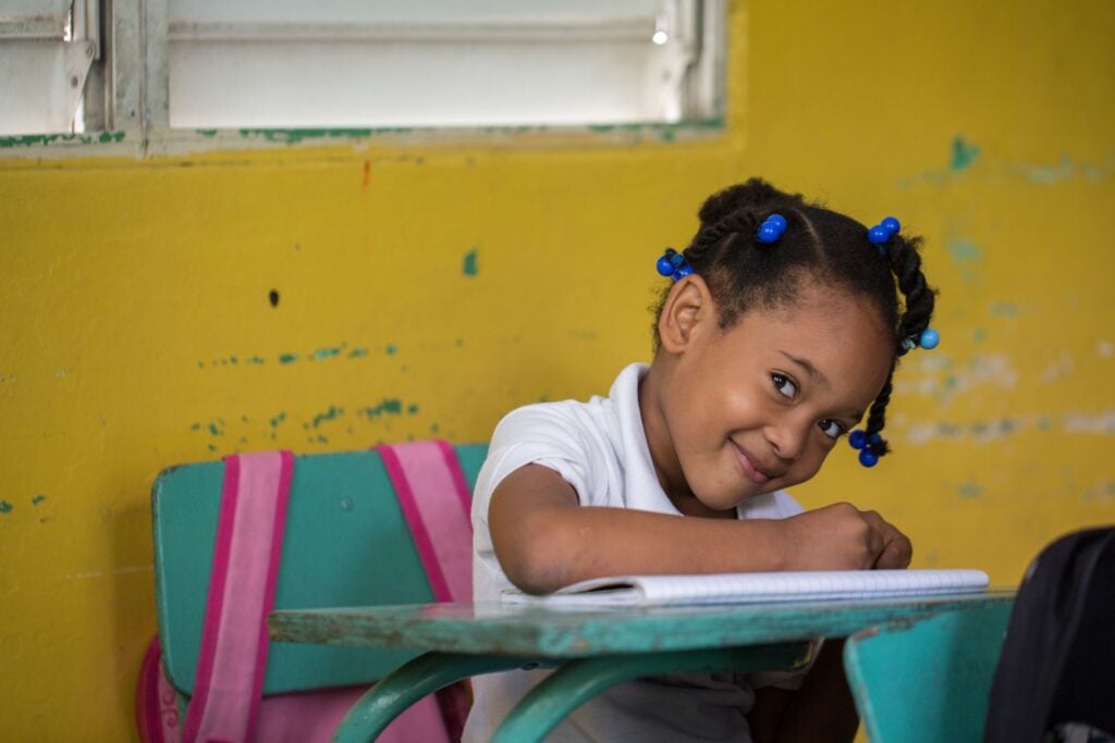 girl student smiling at desk