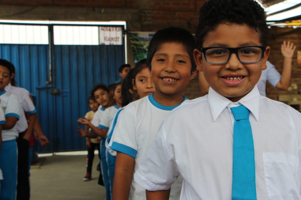 students in Peru in a line smiling