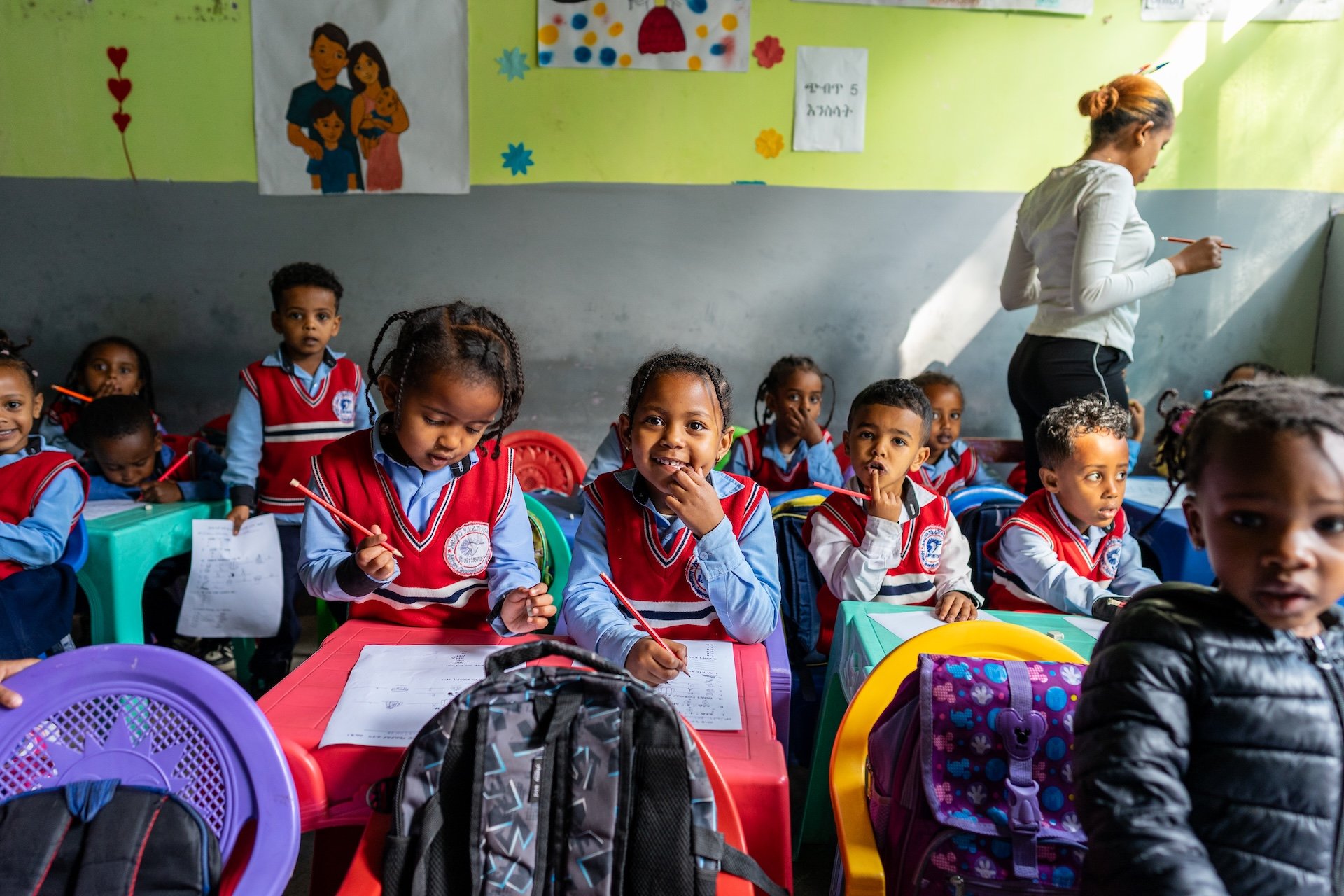 Ethiopia students in a classroom smiling at their desks