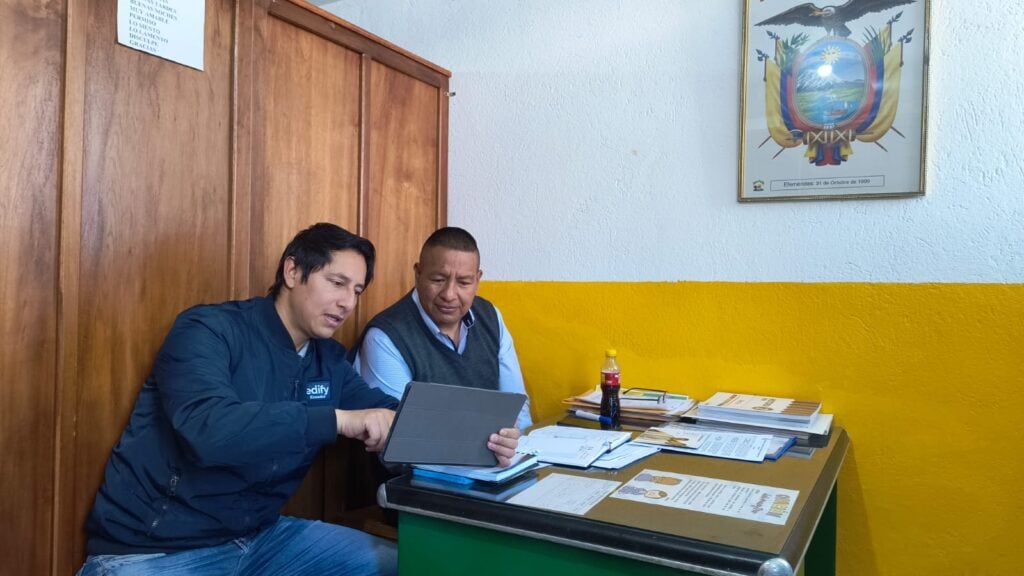 Ecuador school owners at a desk together
