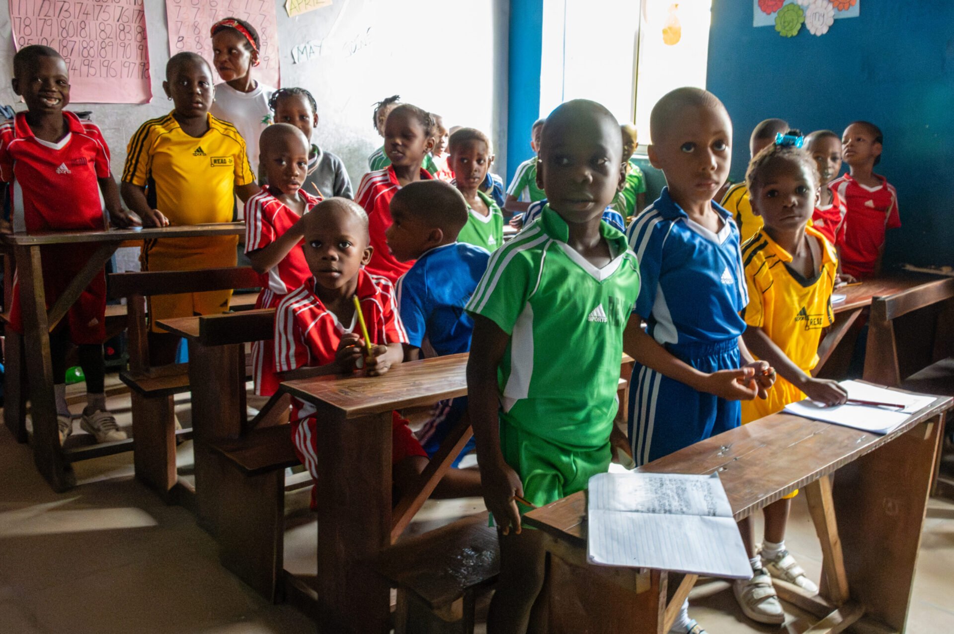 students in Nigeria at desks smiling